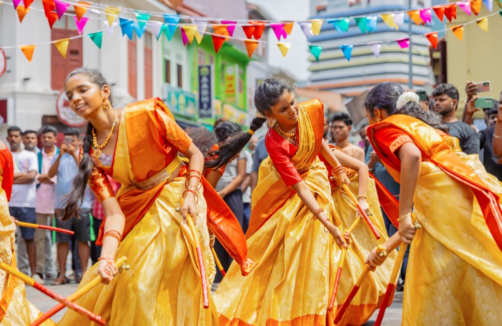 Salangai Kittiyattam dancers mid-step, a kitti stick held in each hand